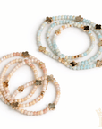 Layered gold quatrefoil bracelet set for boutique fashion styling