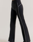 Side view of black contrast trim flare workout pants