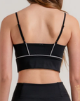 Black activewear top styled with matching flare workout pants