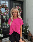 Woman wearing the Hot Pink Ribbed Knit Top featuring soft ribbed knit fabric, a relaxed fit, and vibrant pink color.