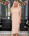 Woman wearing oversized mineral wash midi dress in neutral beige