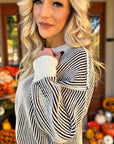 Blonde model showing detail of two tone sweater.