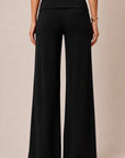 Back view of women's black foldover wide leg pants