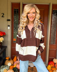 Woman wearing chocolate brown and cream striped quarter zip pullover