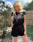 Woman wearing Airflow Contrast Scallop Trim Shorts featuring lightweight airflow fabric, feminine contrast scallop trim, and a relaxed fit.