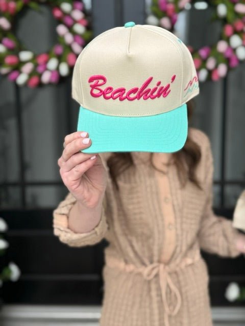 Woman wearing the Beachin' trucker hat with embroidered front design and adjustable snapback closure.