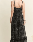 Back view of black floral tiered maxi dress with scalloped detailing
