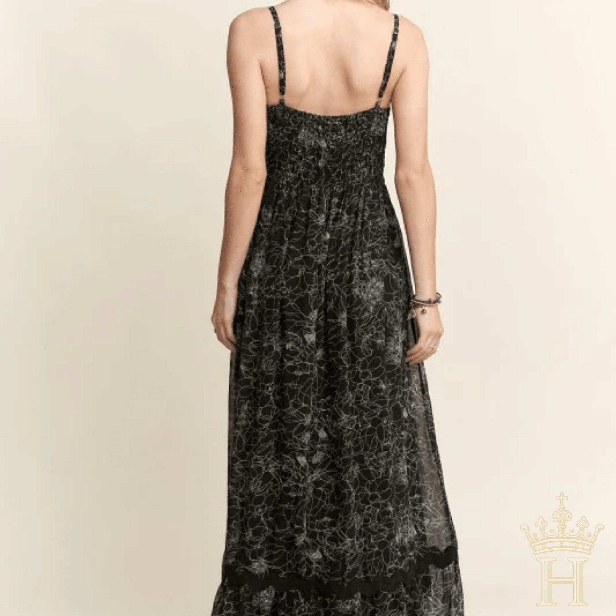 Back view of black floral tiered maxi dress with scalloped detailing
