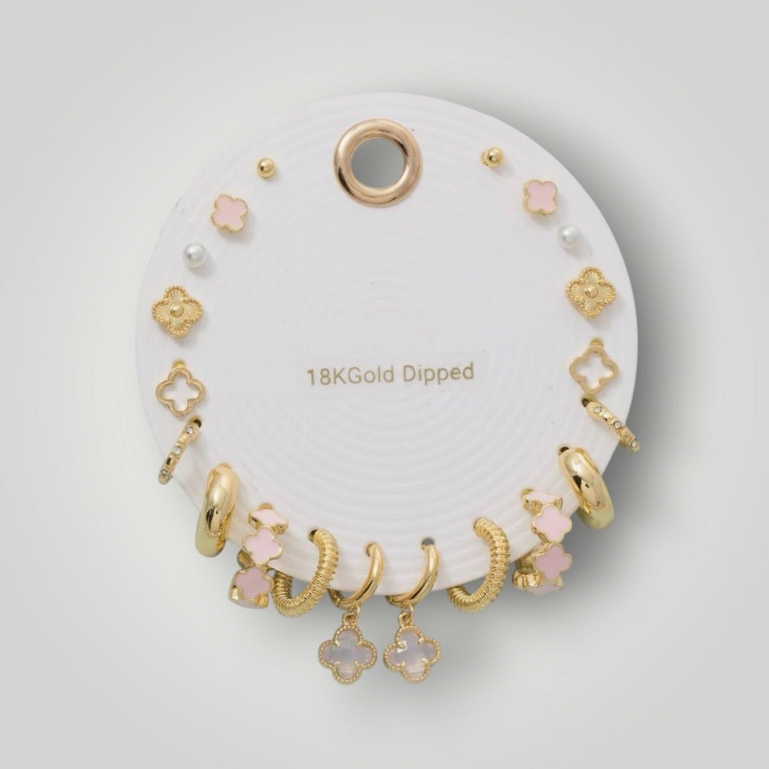 Complete 18K gold dipped earring set featuring blush clover earrings, pearl studs, gold hoops, textured huggies, and sparkling accent earrings.