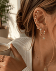 Celestial Dreams 9-pair gold-tone earring set with stars, moons, pearls, crystal studs and huggie hoops.