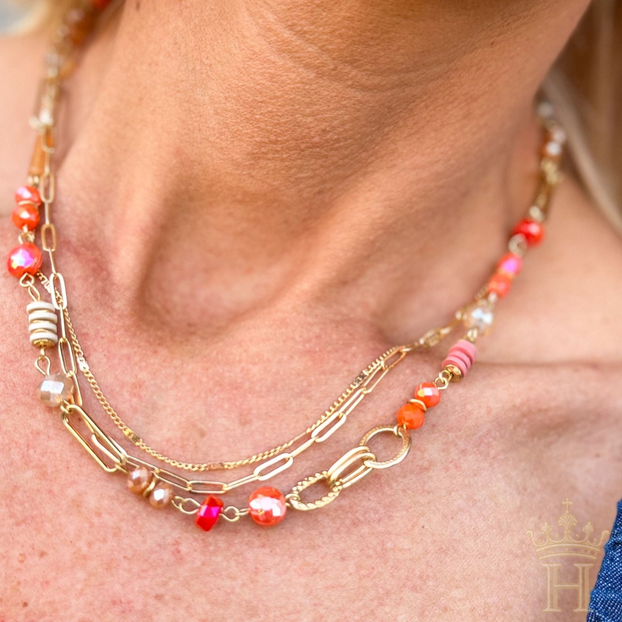 Three-layer necklace set with gold curb and paperclip chains, colorful coral-toned beads, pearl accents, and gold-tone details.