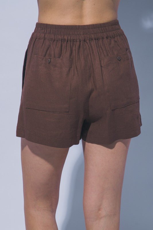 Lightweight brown linen boutique shorts with elastic waistband back view