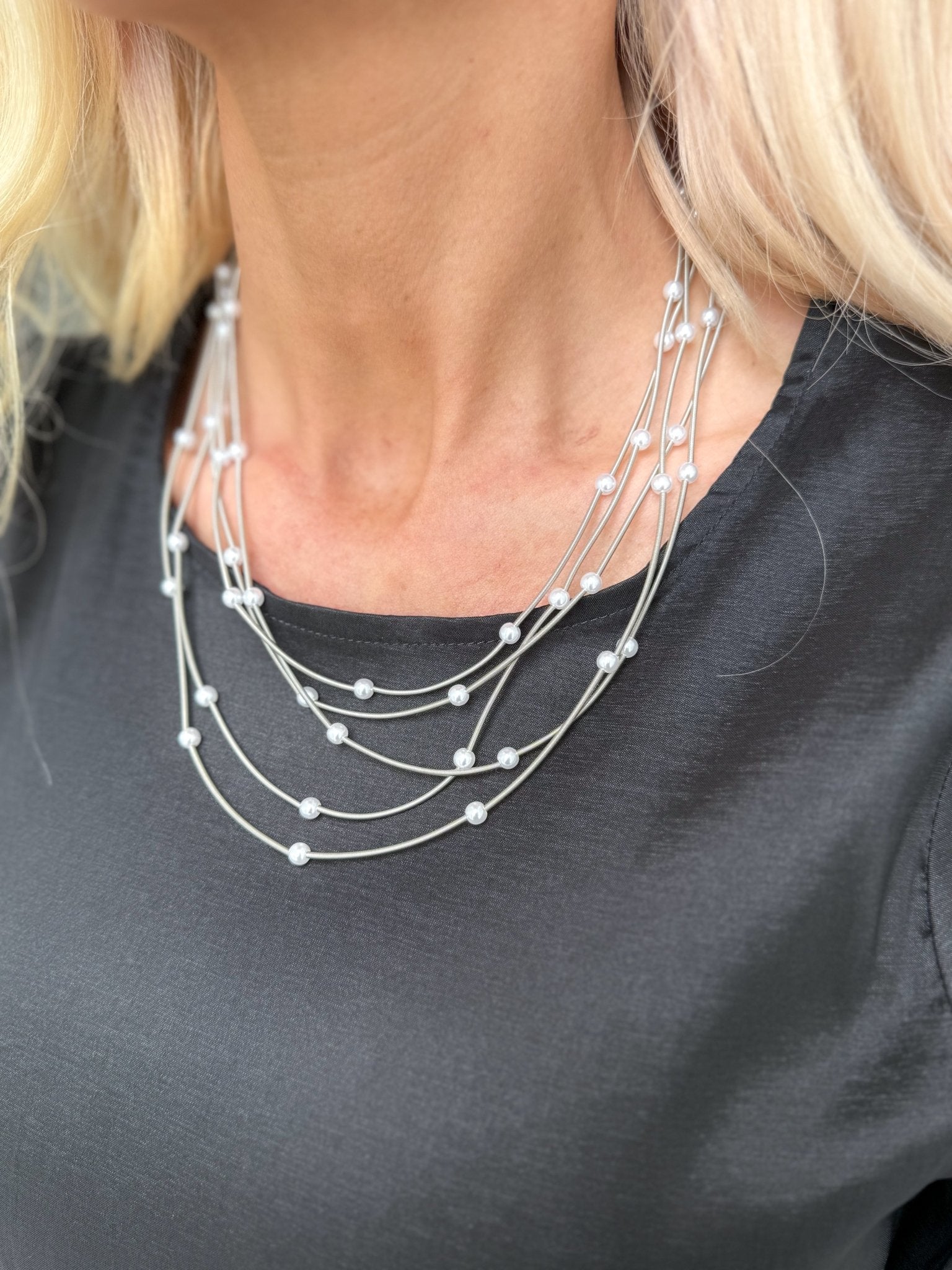 Layered pearl necklace styled for feminine boutique fashion