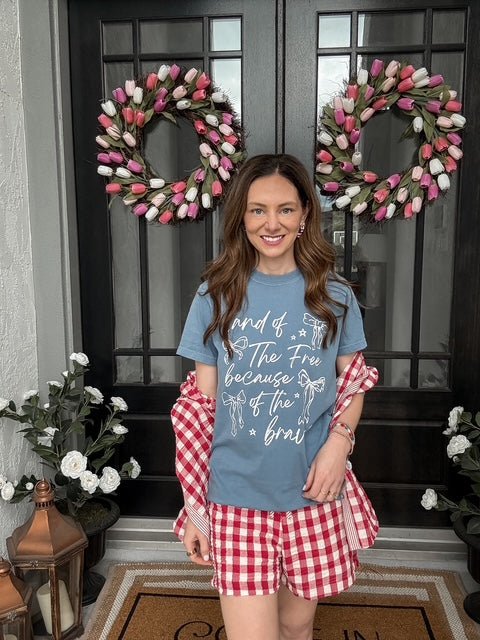 Woman wearing the Freedom State of Mind Graphic Tee featuring a bold patriotic-inspired graphic, crew neckline, and relaxed everyday fit.