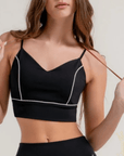 Black fitted workout top with contrast piping detail