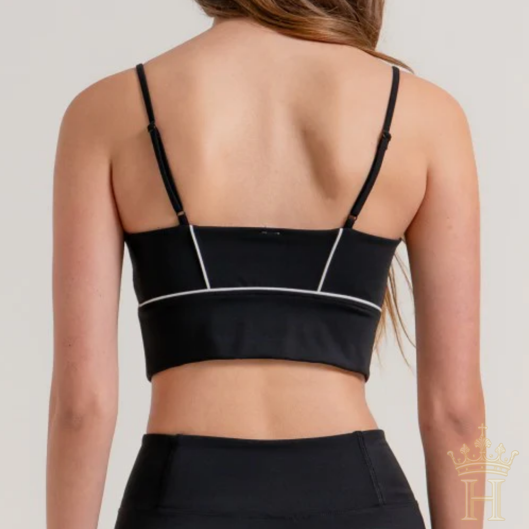 Black activewear top styled with matching flare workout pants