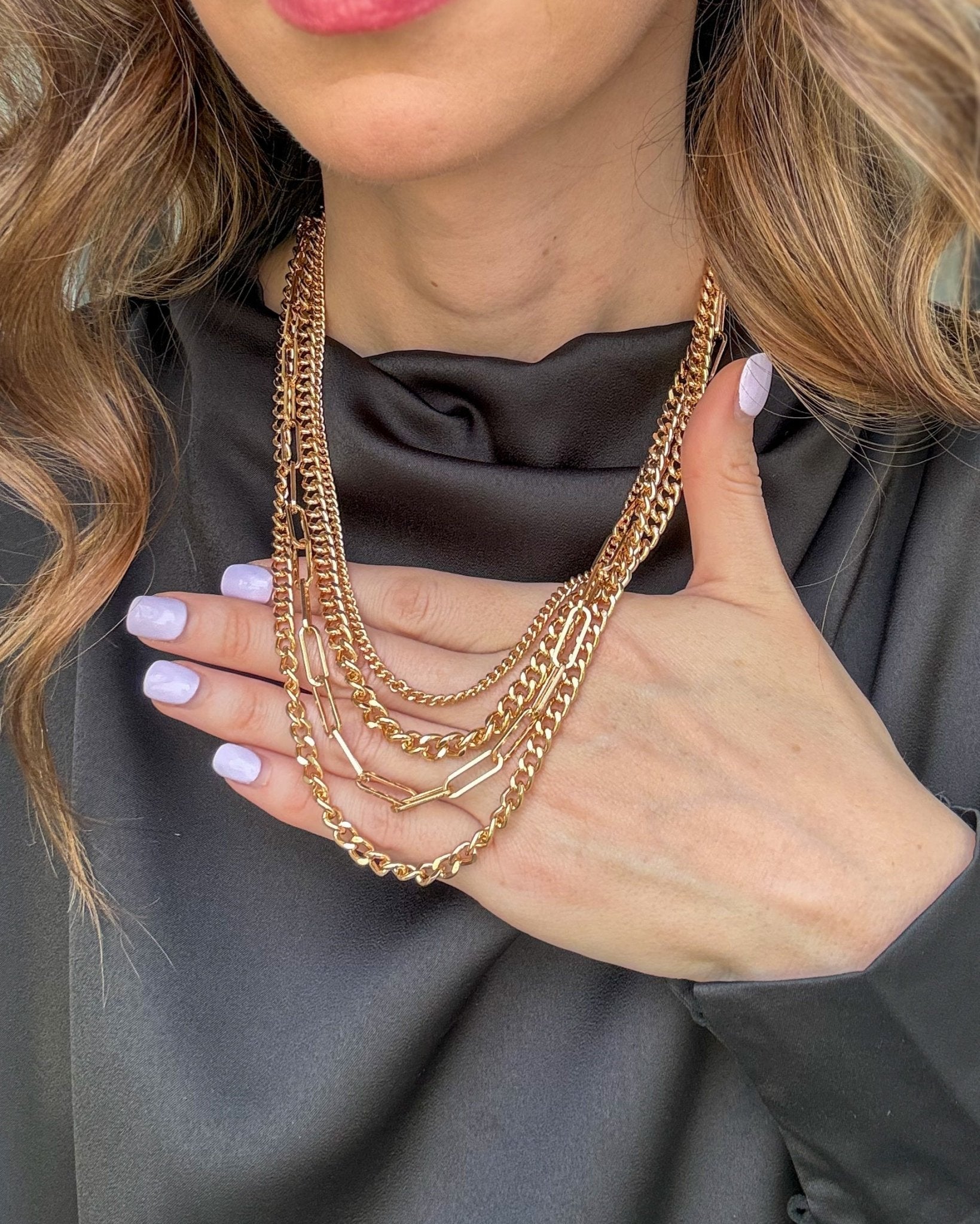 Golden Luxe layered necklace set with four gold-tone curb and paperclip chains and coordinating metallic stud earrings.