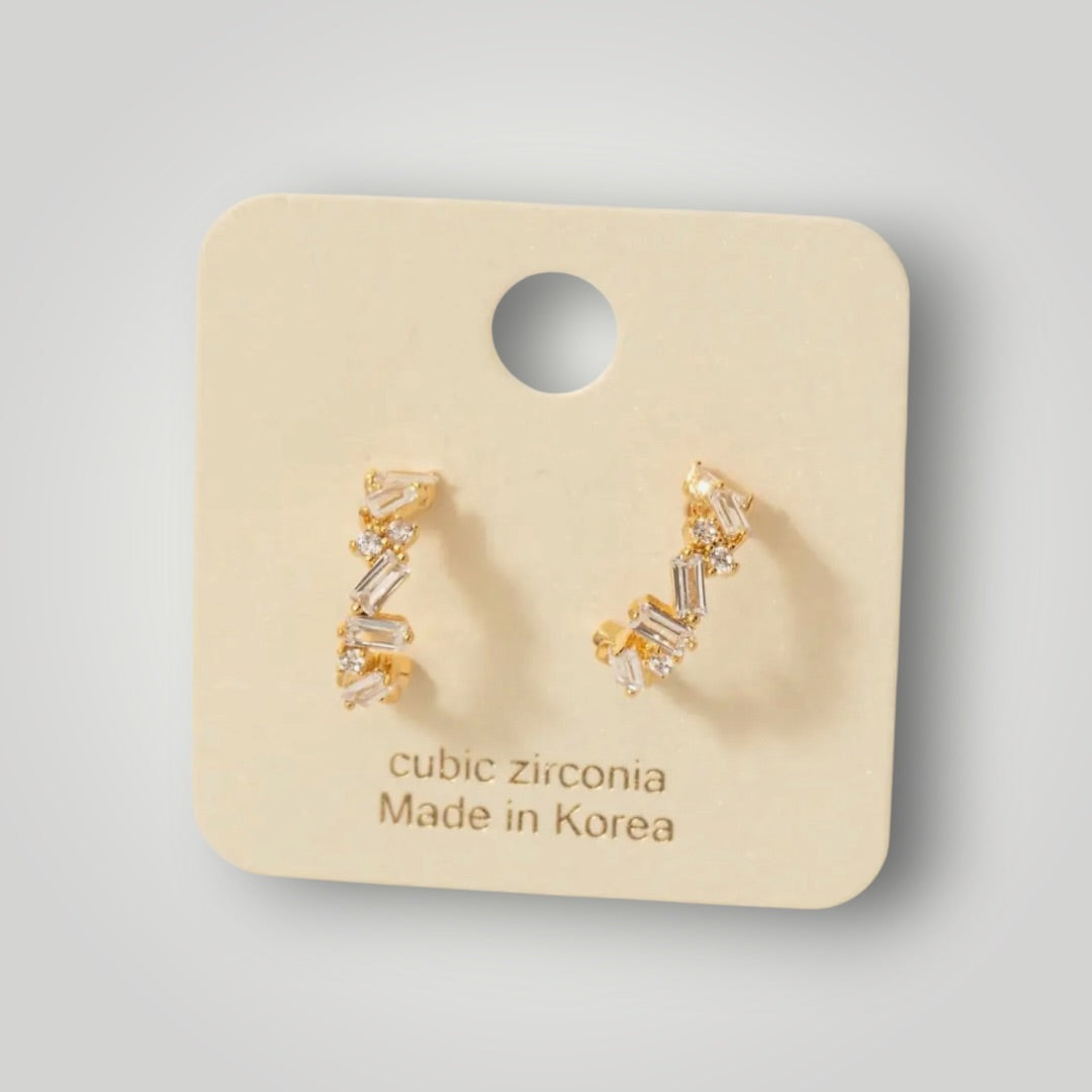 Gold mini hoop earrings featuring sparkling baguette and round cubic zirconia stones.