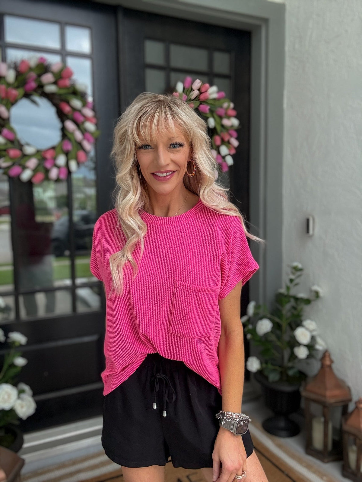 Woman wearing the Hot Pink Ribbed Knit Top featuring soft ribbed knit fabric, a relaxed fit, and vibrant pink color.