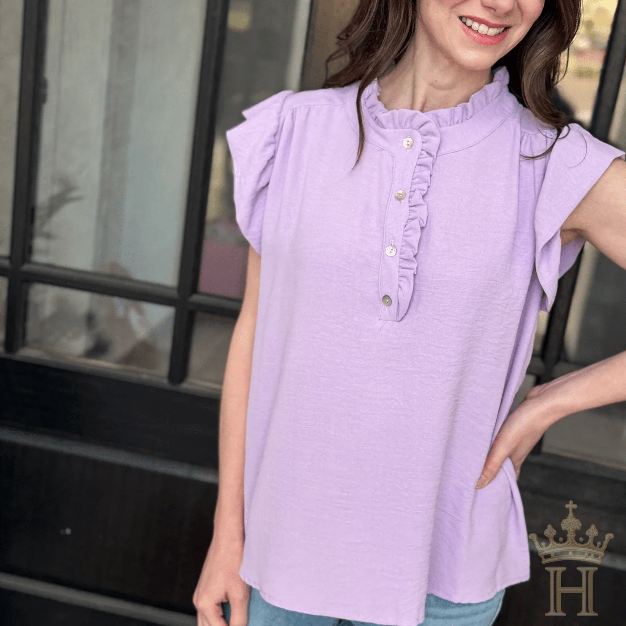 Woman wearing lavender ruffle trim sleeveless boutique top