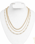 Trendy layered gold necklace with white bead detailing