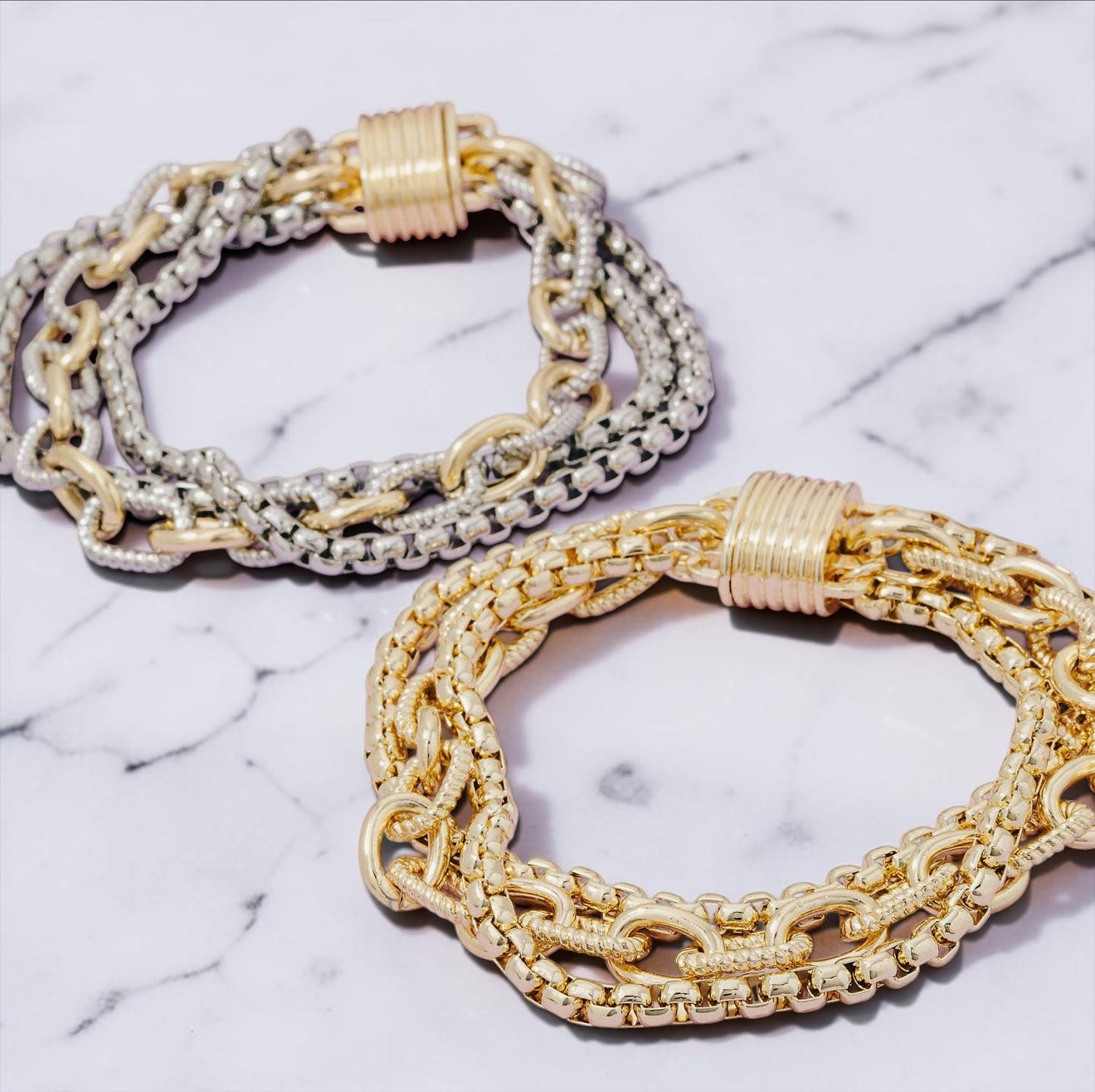 Gold and two-tone magnetic chain bracelets featuring layered gold-plated links and cubic zirconia accents.