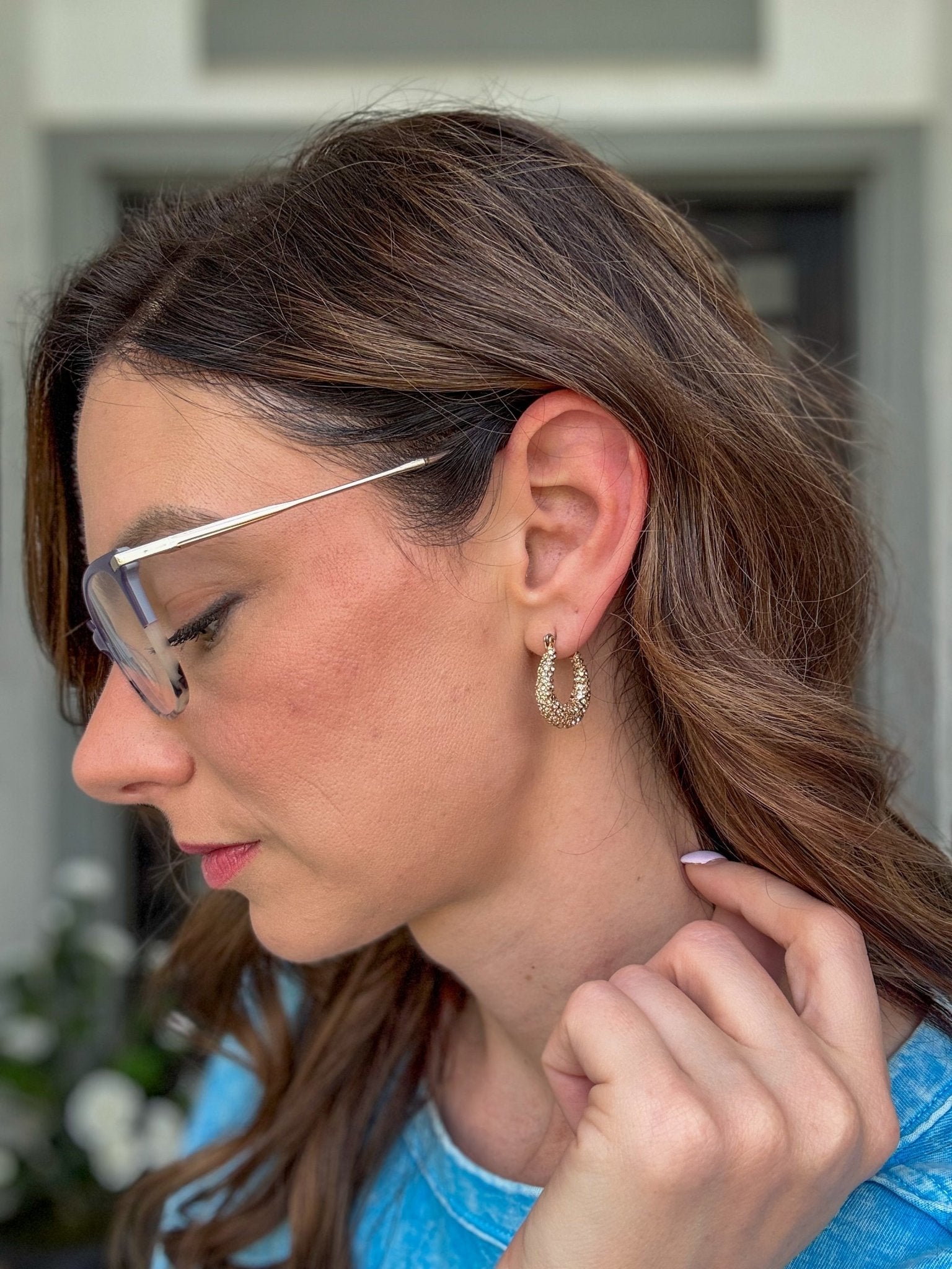 Luxe pavé huggie hoop earrings with graduated sparkling stones, available in gold or silver.