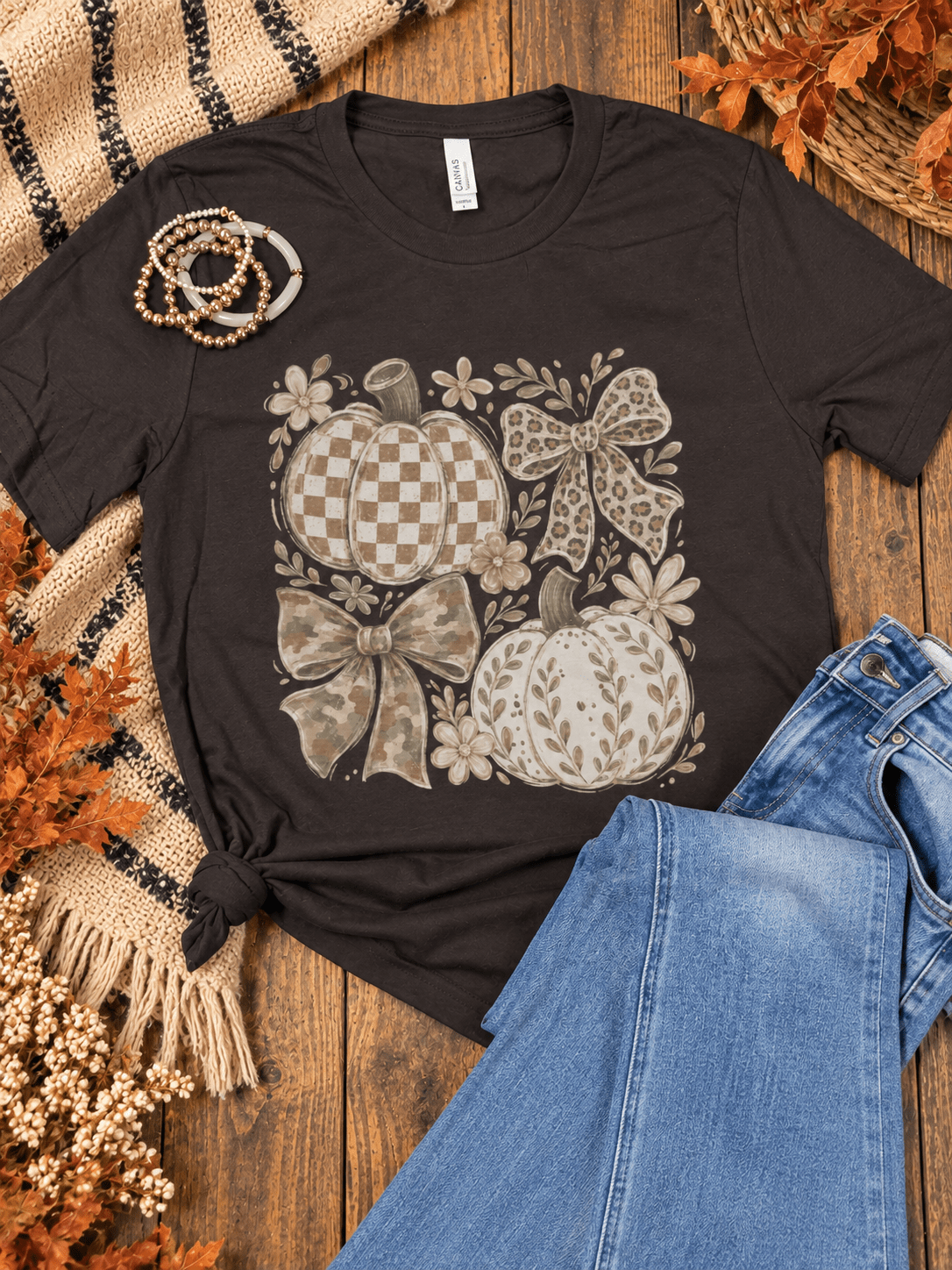 Neutral pumpkin and bow fall graphic tee with checkerboard, leopard and camo details styled with blue jeans from Halemi &amp; Co.