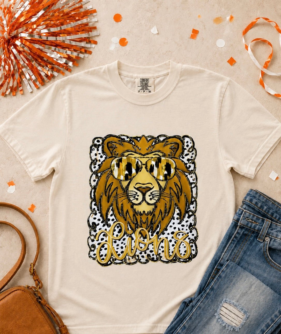 Ivory Comfort Colors Lions football graphic tee with lion sunglasses and gold black spotted details