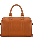 A warm cognac brown faux leather handbag with dual top handles and a detachable shoulder strap, shown against a plain white background.