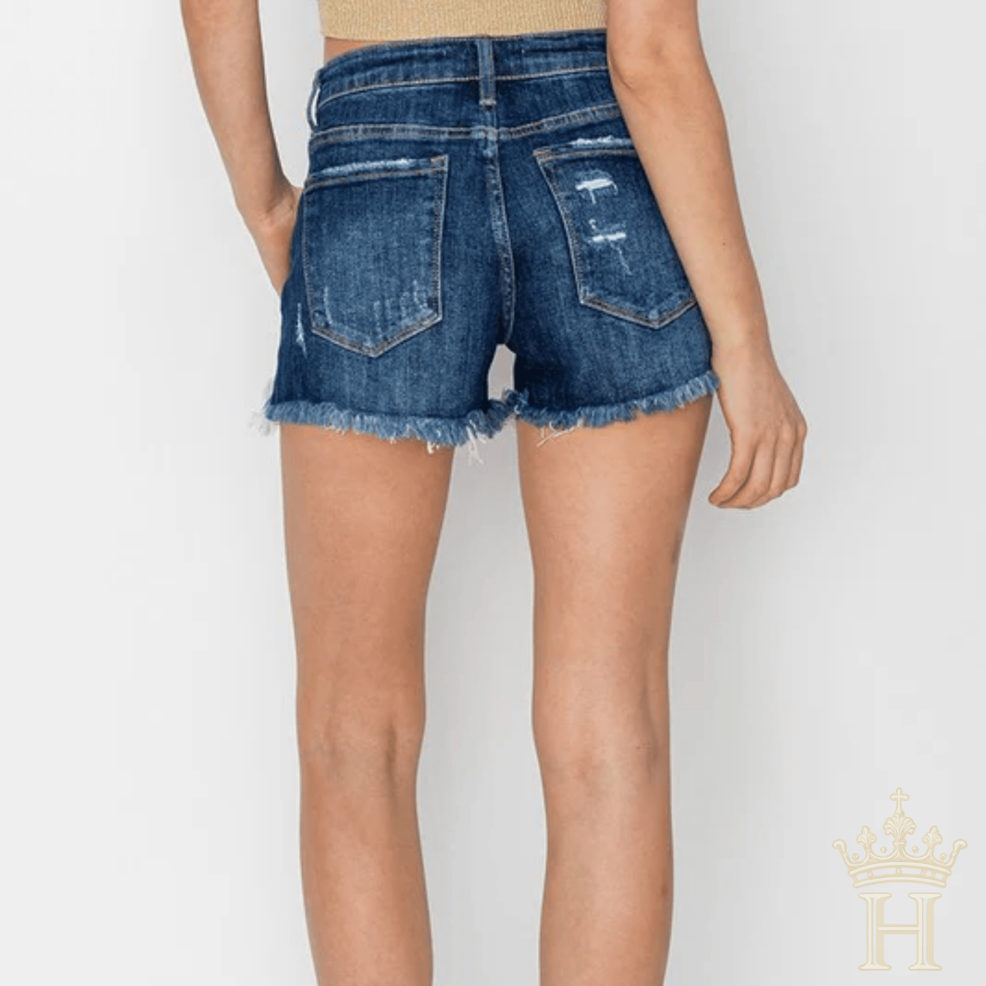 Risen stretch denim shorts with button fly and exposed pocket detailing back view. 