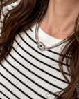Silver-tone necklace featuring a minimalist knot design symbolizing connection and togetherness.
