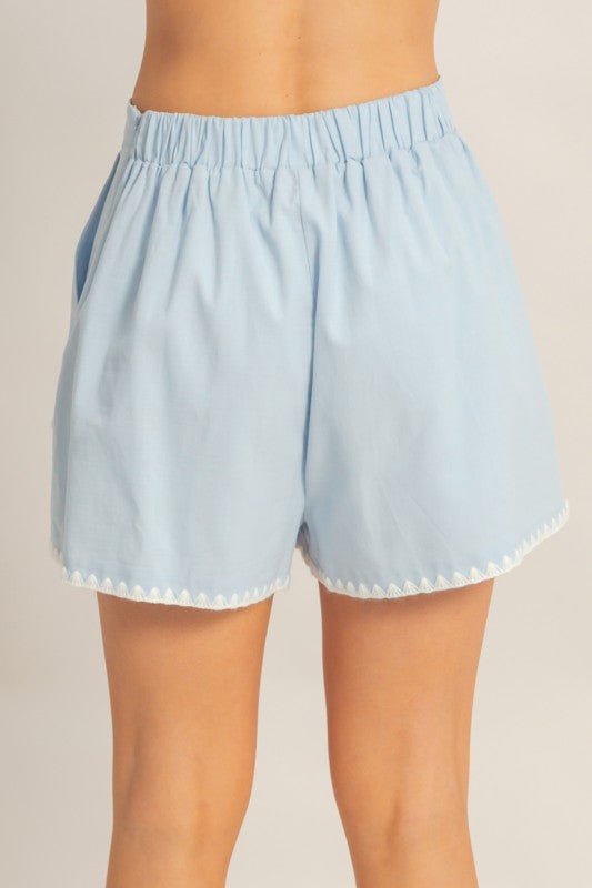 Back view of sky blue scallop trim high-waisted shorts