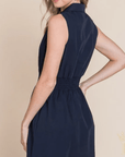 Sleeveless smocked waist mini dress styled for feminine boutique fashion