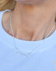 Equestrian-inspired snaffle bit necklace styled for boutique fashion