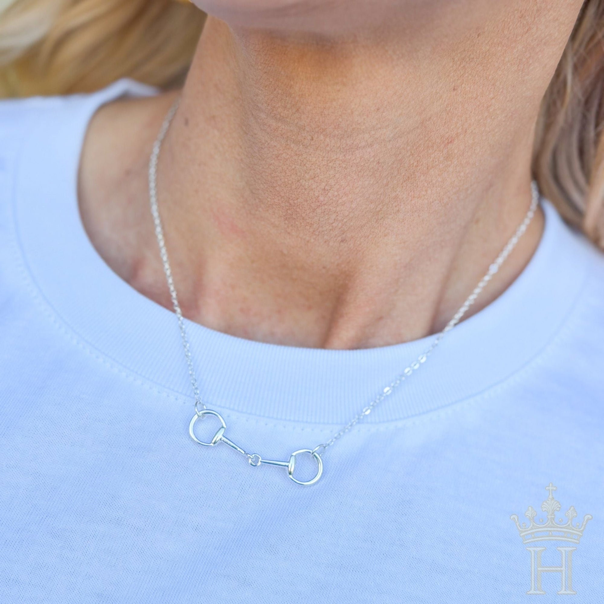 Equestrian-inspired snaffle bit necklace styled for boutique fashion
